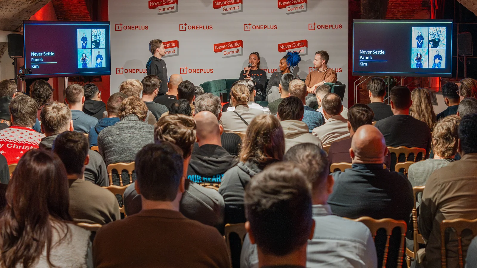 A community panel on stage at the Never Settle Summit