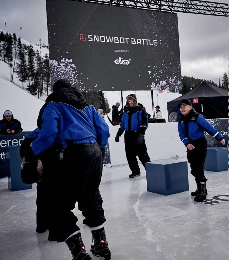 Kids dodging snowballs in the Snowbot arena