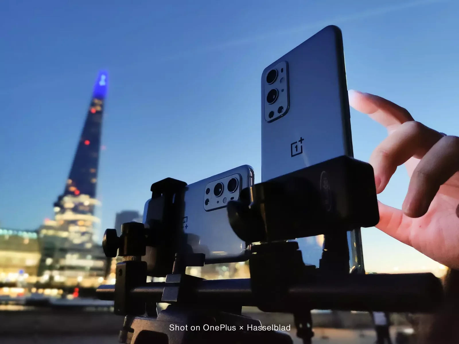 Two OnePlus 9 Series phones on a rig by the Thames, with the Shard behind